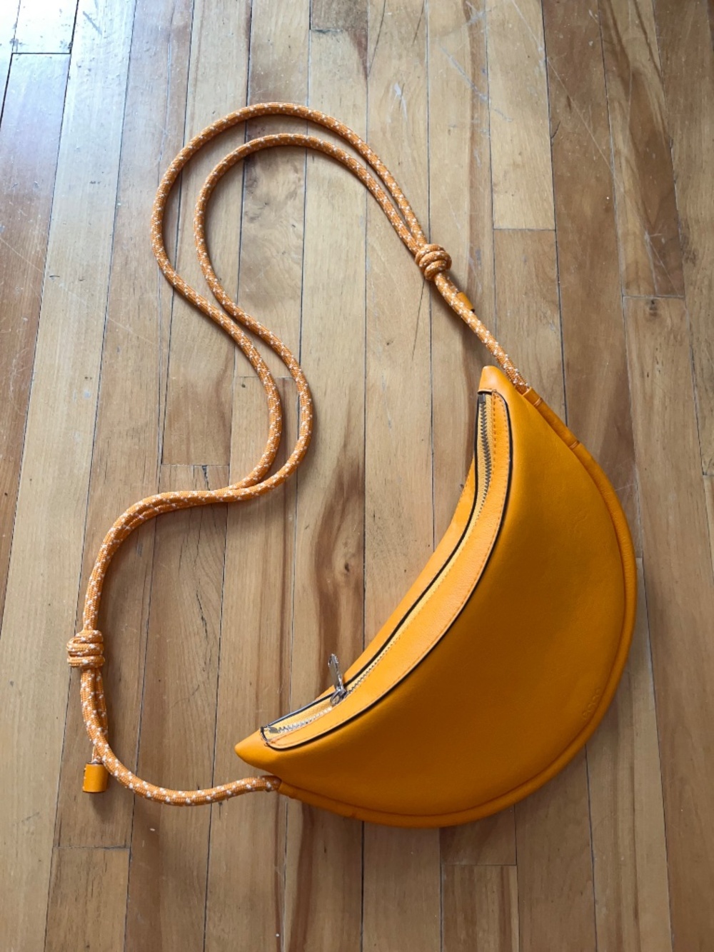 Leather paracord strap crossbody sling bag in orange by Ecco